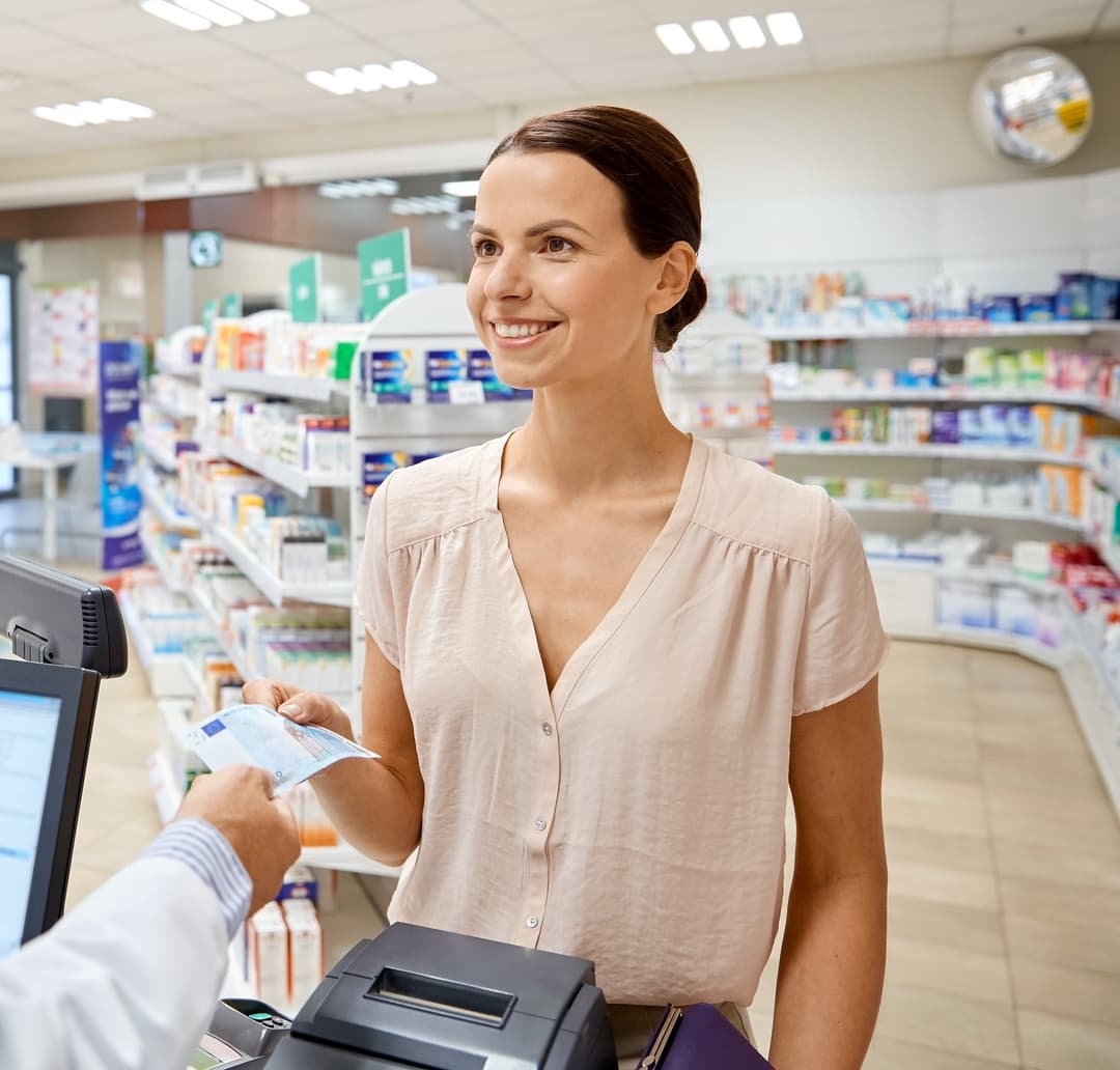pharmacist greeting a patient inside Reimer Pharmacy